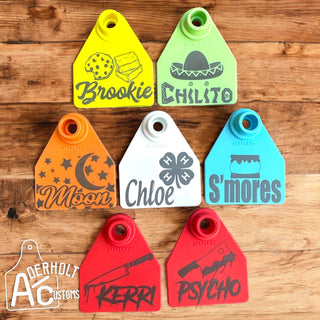 Medium AllFlex small livestock ear tags for sheep, goats and pigs in a variety of colors customized with detailed designs that coordinate with their names.