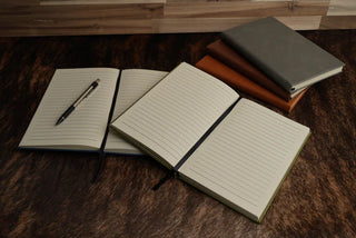 Custom engraved faux leather journals featuring lined paper